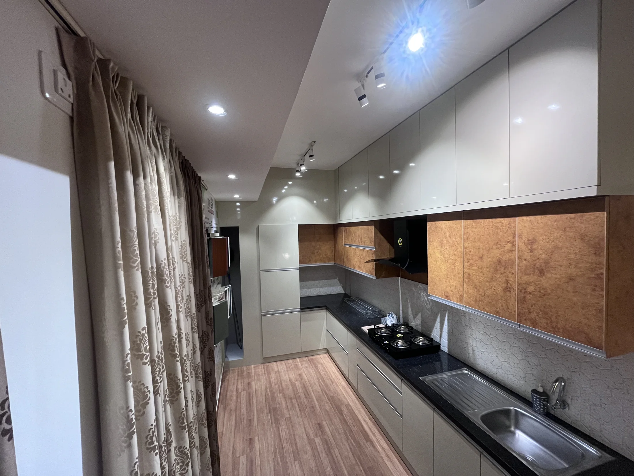 Grey and wood kitchen worktop and cabinetry by SK Spaces
