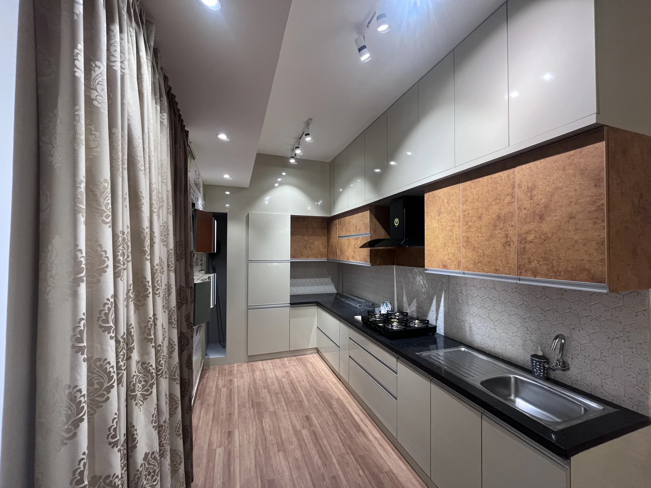 Grey and wood galley kitchen by SK Spaces