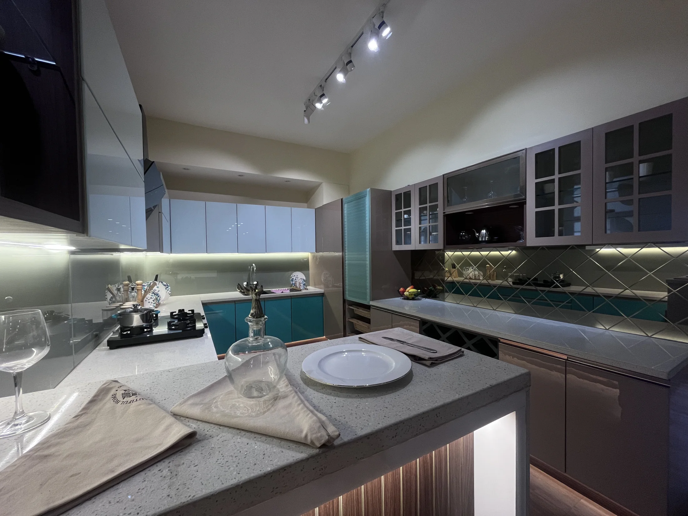 Close view of teal kitchen cabinetry and fittings by SK Spaces